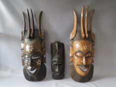 TWO LARGE CARVED HARDWOOD TRIBAL MASKS WITH DECORATIVE INLAY, tallest H 94 cm, together with a