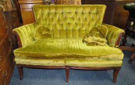 AN ANTIQUE MAHOGANY FRAMED SMALL UPHOLSTERED SETTEE, carved roundel detail to the frame, W 131 cm