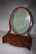 A REGENCY MAHOGANY AN INLAID DRESSING MIRROR, the oval mirror held by shaped supports and a