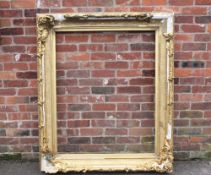 A LARGE 19TH CENTURY GOLD DECORATIVE SWEPT FRAME - WITH DAMAGES, frame W 17 cm, rebate 120 x 97 cm
