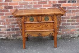 AN ANTIQUE CHINESE ELM TWO DRAWER COFFER / ALTER TABLE, having a tray type rectangular top above two