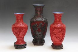 A LARGE ORIENTAL CINNABAR VASE ON HARDWOOD STAND, red ground heightened in black with blue enamel