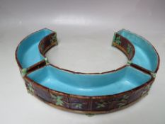 A SET OF THREE MINTON MAJOLICA CURVED CERAMIC TROUGHS, wood panel effect to exterior with fruit