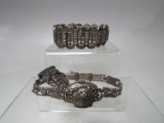 AN ART DECO STYLE SILVER AND MARCASITE PANEL LINK BRACELET, each hinged link marked silver to