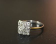 AN 18 CT WHITE GOLD PAVE STYLE DIAMOND CLUSTER RING, having 21 brilliant cut diamonds in a square