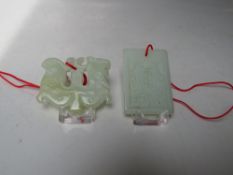 A CHINESE JADE CARVED AND PIERCED FIGURAL PENDANT, W 5.8 cm together with a rectangular pendant with