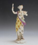 AN ANTIQUE HARD PASTE FIGURINE, as a female figure reading from a book, in the style of Serves,
