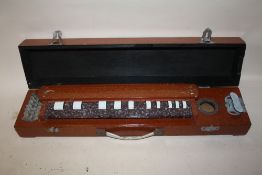 AN UNUSUAL WOODEN CASED ZITHER STYLE STRINGED INSTRUMENT