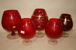 A COLLECTION OF FIVE DECORATIVE LARGE RED GLASS VASES ON STANDS, TALLEST H. 33 CM