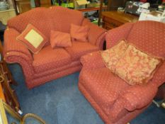 A MODERN RED UPHOLSTERED TWO PIECE LOUNGE SUITE AND A OTTOMAN (3)