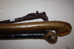 A CARVED WOODEN HANDLED WALKING CANE WITH FOX AND STAG DETAIL, TOGETHER WITH TWO OTHER WALKING