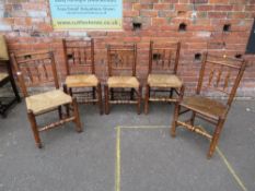 AN ANTIQUE MIXED SET OF FIVE OAK WICKER SEAT CHAIRS