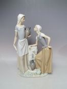 A LARGE NAO FIGURINE OF TWO LADIES COLLECTING WATER, H 39 cm, S/D