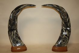 A PAIR OF LARGE CARVED BUFFALO HORNS ON WOODEN PLINTHS, H 48 CM