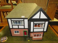 A VINTAGE DOLLS HOUSE IN A MOCK TUDOR STYLE WITH FURNITURE AND ELECTRICS H-54 CM W-55 CM
