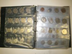 AN ALBUM OF BRITISH AND WORLD COINS TO INCLUDE AN 1897 CROWN, REPRODUCTION COINS, FIVE POUND COINS