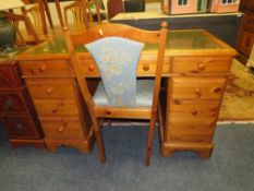 A HONEY PINE LEATHER TOPPED TWIN PEDESTAL DESK H-76 W-122 CM WITH A CHAIR