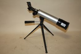 A SMALL MODERN ASTRONOMICAL TELESCOPE ON TRIPOD BASE