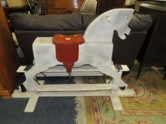 A WOODEN CHILDS TRESTLE ROCKING HORSE