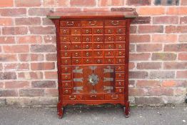 A CHINESE HARDWOOD APOTHECARY CHEST OF SLIM PROPORTIONS, having an arrangement of forty four drawers