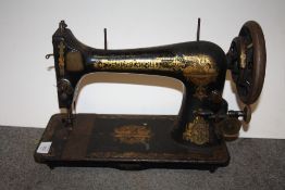 AN UNCASED VINTAGE SINGER SEWING MACHINE