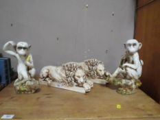 A PAIR OF CONTEMPORARY RESIN LIONS TOGETHER WITH A PAIR OF HUMOROUS MONKEYS