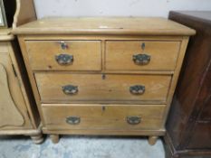 AN ANTIQUE PINE FOUR DRAWER CHEST ON BUN FEET H-89 W-89CM