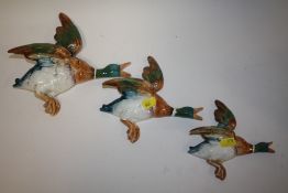 A SET OF THREE BESWICK FLYING MALLARD WALL PLAQUES