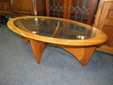A RETRO TEAK AND GLASS TOPPED OVAL COFFEE TABLE W 120 cm