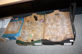 THREE TRAYS OF GLASSWARE TO INCLUDE STEWART CRYSTAL DRINKING GLASSES AND ISLE SCULPTURED GLASS