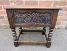 A SMALL CARVED OAK SEWING BOX RAISED ON BOBBIN TURNED SUPPORTS, H-46 W-48 CM