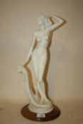 A MODERN RESIN NUDE FEMALE FIGURE ON WOODEN PLINTH BY PEGASUS OF PORTUGAL, H 48 CM