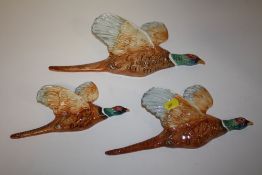 A SET OF THREE BESWICK WALL HANGING GRADUATED FLYING PHEASANTS