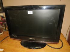 A SMALL SAMSUNG FLATSCREEN TV - WITH REMOTE