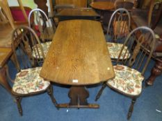 AN OAK DECORATIVE TABLE WITH FOUR ERCOL STYLE CHAIRS