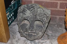 A STONE CARVED FACE