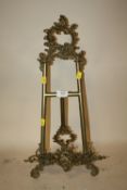 A 20TH CENTURY ROCOCO STYLE BRASS TABLE TOP PICTURE EASEL, H. 56 CM, W. 27 CM