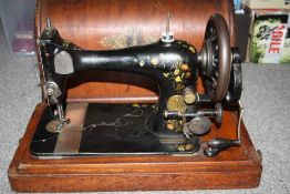 A VINTAGE CASED SINGER SEWING MACHINE