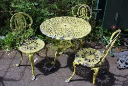 A METAL GARDEN TABLE AND THREE CHAIRS
