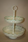 A MODERN ENAMELLED TWO TEAR CAKE STAND WITH PIERCED DETAIL