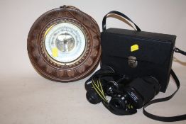 A CARVED OAK CIRCULAR WALL BAROMETER TOGETHER WITH A PAIR OF MIRANDA 8X40 BINOCULARS