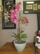 A CONTEMPORARY FAKE ORCHID FLOWER CENTREPIECE