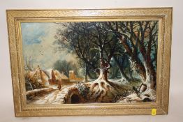 A GILT FRAMED OIL ON BOARD DEPICTING A RURAL WOODED VILLAGE SCENE WITH FIGURE CROSSING A BRIDGE