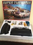 A 'SUPER TURISMOS' SCALEXTRIC SET, TOGETHER WITH ADDITIONAL CARS, ACCESSORIES AND EXTRA TRACK