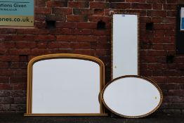 A MODERN GILT FRAMED ARCHED OVER MANTEL MIRROR 100 CM BY 70 CM TOGETHER WITH A TALL RECTANGULAR