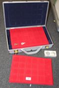 AN EMPTY HARD CASE WITH EMPTY COIN COLLECTOR TRAYS