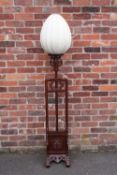 A CHINESE HARDWOOD ADJUSTABLE LAMP STANDARD WITH SHADE, with typical carved and pierced decoration