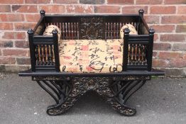 AN ANTIQUE EASTERN EBONISED ELEPHANT CHAIR, the rectangular seat with carved and spindle sides,