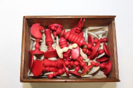 A BOX OF VINTAGE HAND CARVED CHESS PIECES