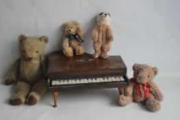 A CHILD'S TOY PIANO TOGETHER WITH A VINTAGE TEDDY BEAR, a Russ teddy bear, a Leosco meerkat and a